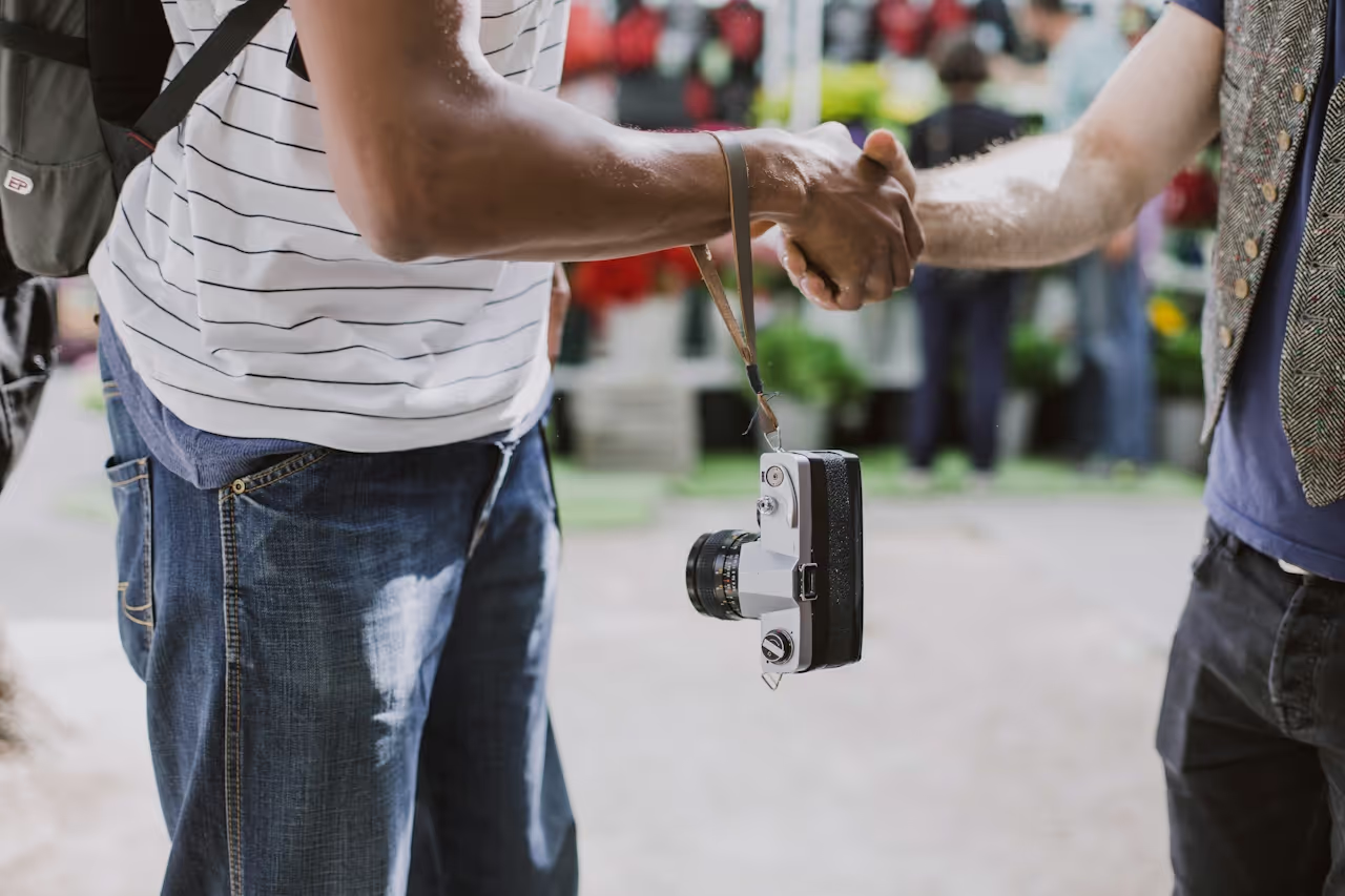 shaking hands with a camera.png